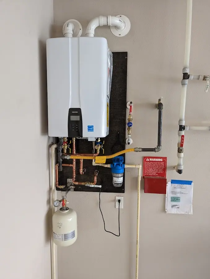 Professional plumber installing copper piping in a Great Barrington home